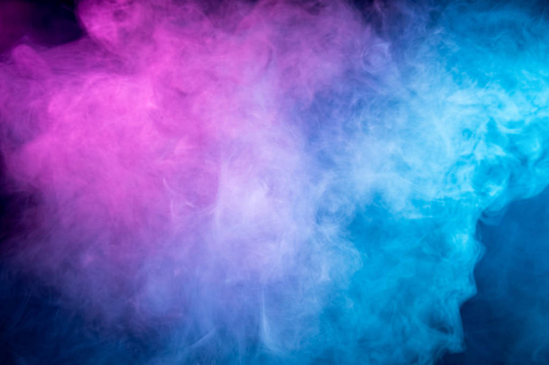 Fog colored with bright pink  and blue gel on dark background. Abstract artwork. Trendy wallpaper.  - Foto, afbeelding