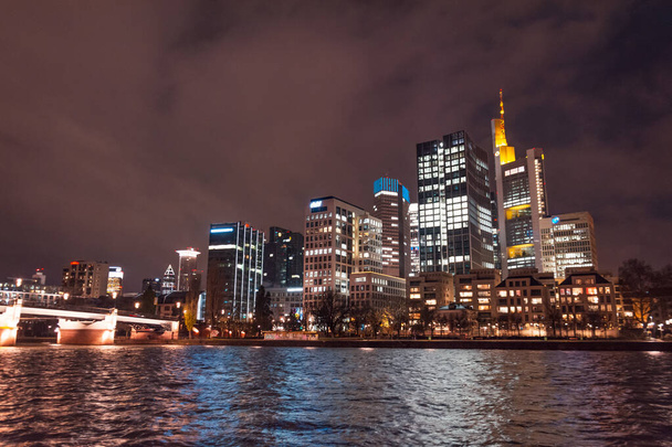 Night view from the embankment of the Main river, on the business center of Frankfurt, Germany. - Photo, image