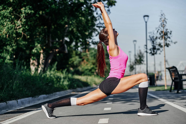 Fitness young woman stretching legs after run. outdoors sport portrait - Φωτογραφία, εικόνα