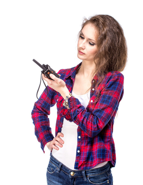 Attractive young woman in a checkered shirt with walkie talkie - Foto, immagini