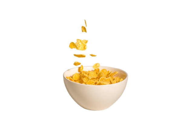 Corn flakes falling to the white bowl. Motion.  - Photo, Image