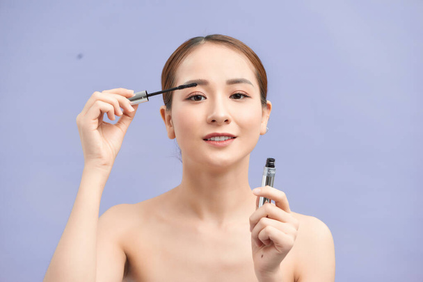 beautiful young woman applied mascara, studio beauty portrait - Фото, изображение