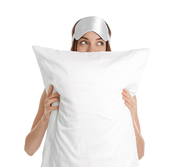 Beautiful woman with pillow and sleep mask on white background. Bedtime - Photo, Image