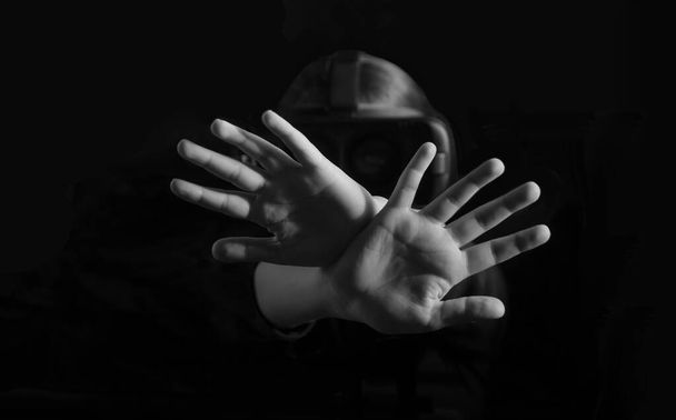 serious, unhappy, confident young girl holding two arms crossed, gesturing no sign, looking at VR device,  on black background - Foto, Imagem