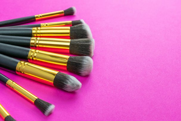Pink background. Makeup brushes isolated on pink with copy space - Photo, Image