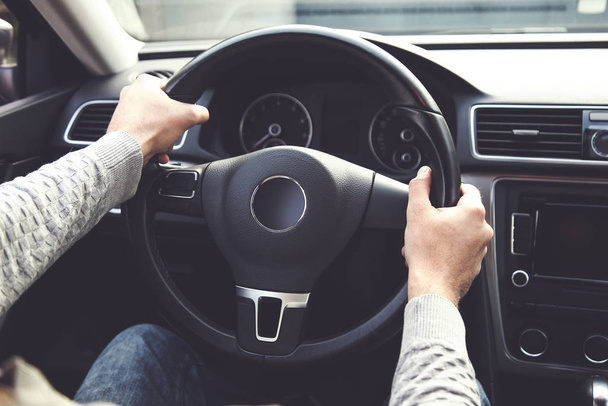 Man holding steering wheel and driving his car - Fotoğraf, Görsel