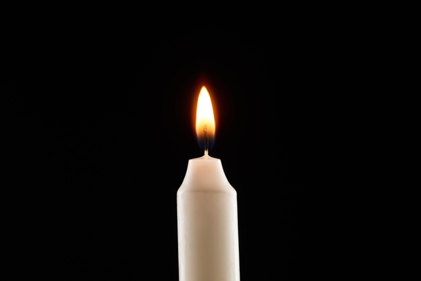 płonąca biała świeca świecąca na czarno - Zdjęcie, obraz