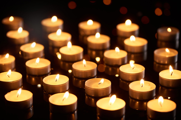selective focus of burning candles glowing in darkness - Photo, Image