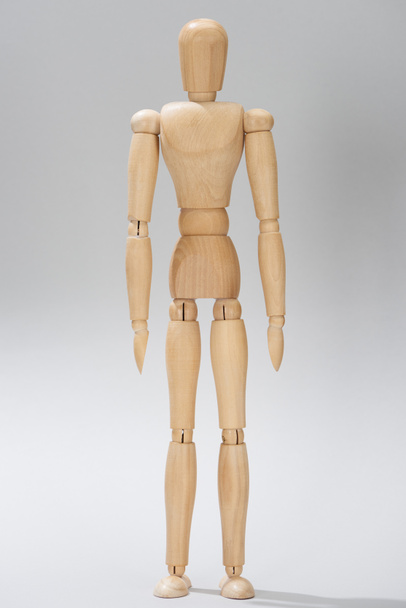 Wooden doll with hinges on grey background - Zdjęcie, obraz