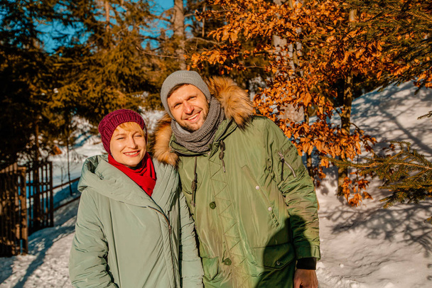 Couple in winter jackets in a forrest - Photo, Image