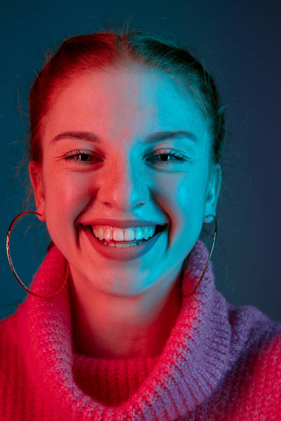 Caucasian womans portrait isolated on gradient studio background in neon light - Foto, Bild