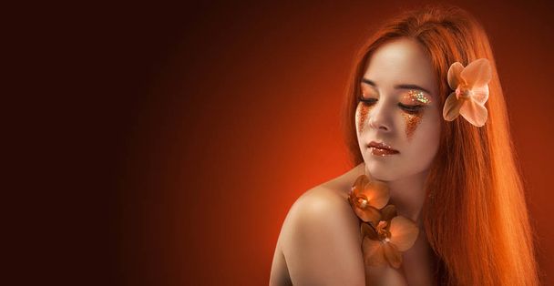 beauty womans portrait. evening make-up on the orange bokeh background - Foto, Imagem