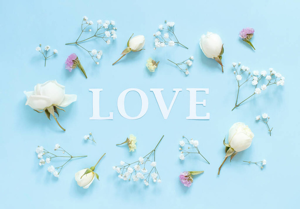 Flowers and word LOVE on a light blue background - Zdjęcie, obraz