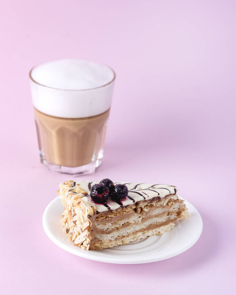 Piece of Tasty Homemade Cake Decorated with Berry and Glass of Latte Pink Background Vertical Tasty Homemade Dessert - Photo, Image