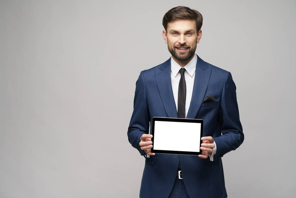 Young Businessman presenting digital tablet pc pad with blank screen - Fotó, kép