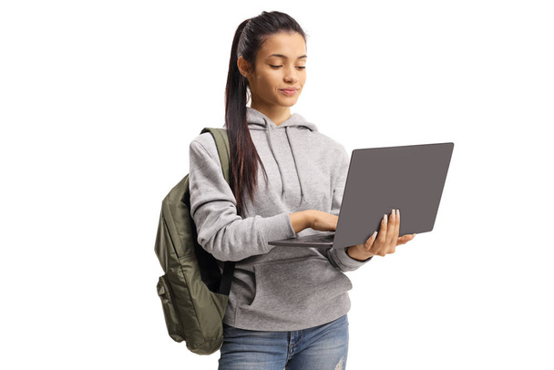 Girl with a backpack typing on a laptop - Foto, Imagem