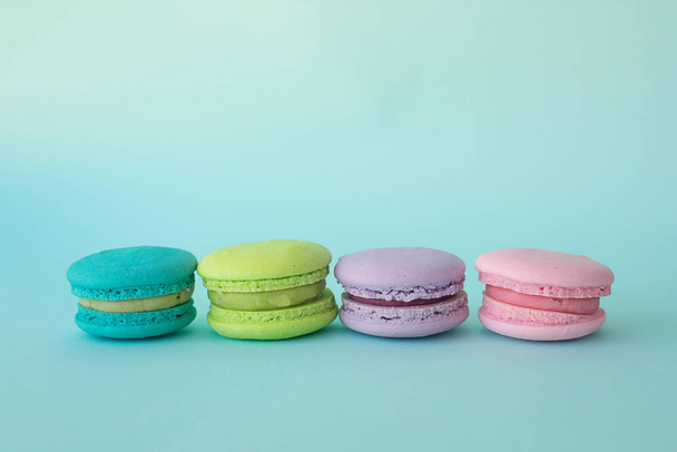 colorful macaroons on a blue textural background - Fotoğraf, Görsel