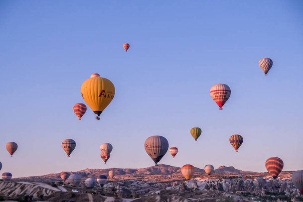 Hot air balloon flying over spectacular Cappadocia. - Foto, afbeelding
