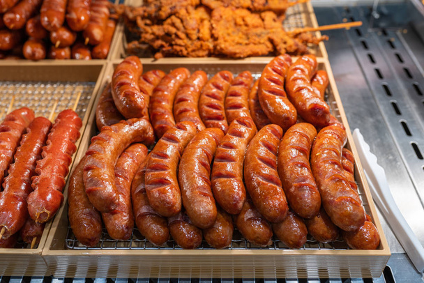 Tasty fried sausage for sale at street food night market - 写真・画像