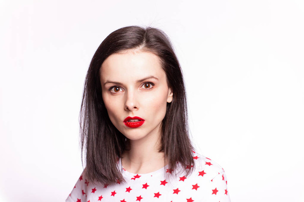 beautiful girl with red lips in a white T-shirt with red stars, portrait - Фото, зображення