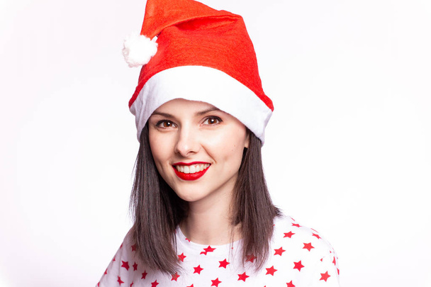 beautiful girl in a t-shirt with a star and a santa claus hat, with red lipstick on her lips - Фото, зображення
