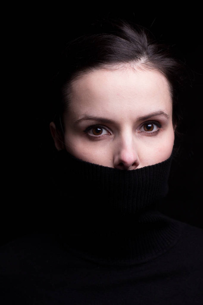 emotional girl in a black turtleneck on a black background - Valokuva, kuva