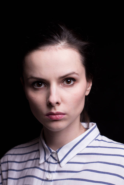 emotional girl in a striped shirt on a black background - Fotografie, Obrázek