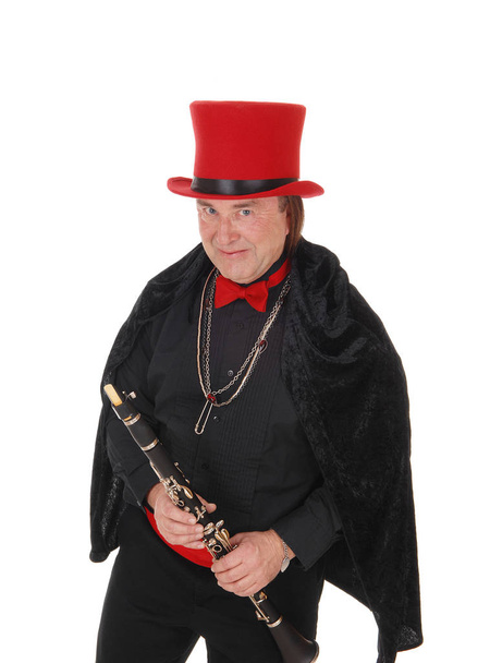 Un clarinettiste avec un chapeau rouge et une tenue noire
 - Photo, image