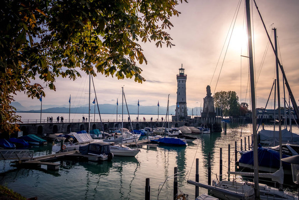 Lindau, Bodensee, Lighthouse and boats pier at sunset - Photo, Image