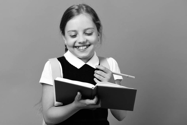 Back to school and education concept. Girl holds blue book - Φωτογραφία, εικόνα