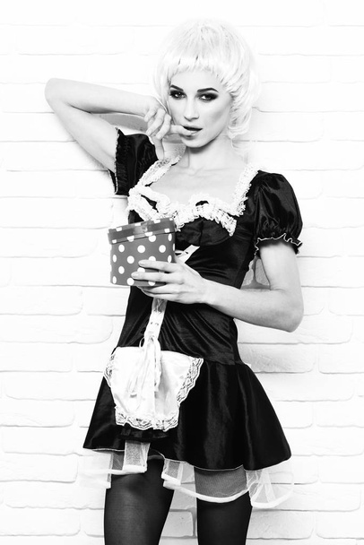 waitress or maid sexy girl on white brick wall background - 写真・画像