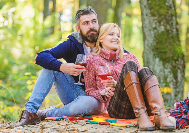 Table for two. couple in love relax in autumn forest. Family picnic. Valentines day. cheers. Red wine in fall weather. happy woman and bearded man drink wine. love date and romance. Spring mood - Fotografie, Obrázek