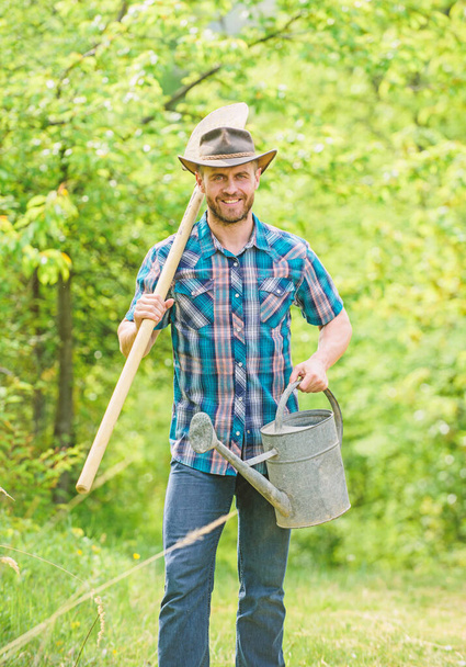 Growing plants. Mature guy cowboy hat with watering can and shovel. Arbor day. Planting trees. Commitment and responsibilities. Agriculture concept. Planting in garden. Tree planting tradition - Foto, Imagem