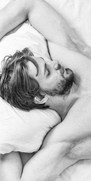 Expert tips on sleeping better. Bearded man sleeping face relaxing on pillow. How much sleep you actually need. Man handsome guy lay in bed. Get adequate and consistent amount of sleep every night - Fotoğraf, Görsel