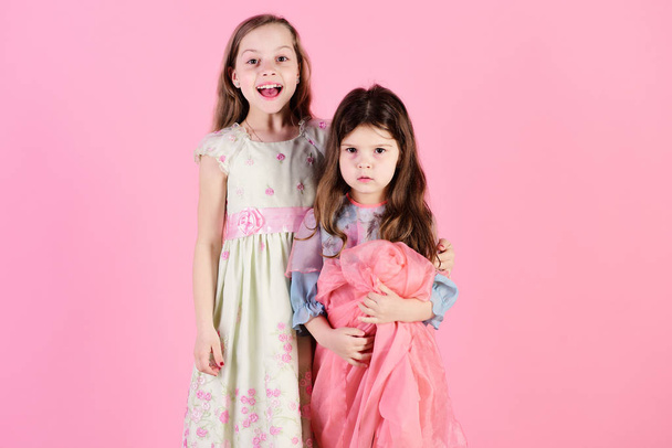 Sisters hold pink cloth. Childhood and family concept. - Foto, immagini