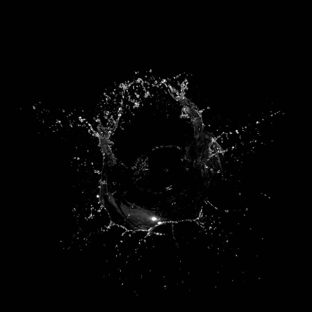 Water splashing isolated over a black background. - Photo, Image