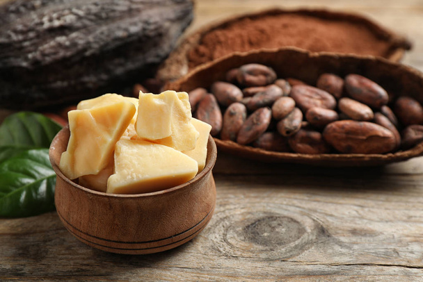 Organic cocoa butter on wooden table, closeup. Space for text - Photo, Image