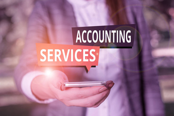Text sign showing Accounting Services. Conceptual photo analyze financial transactions of a business or a demonstrating Woman in grey suites holds mobile phone. - Photo, Image