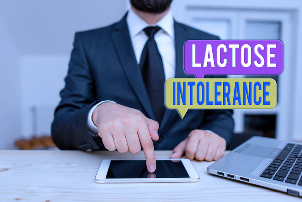 Word writing text Lactose Intolerance. Business concept for digestive problem where body is unable to digest lactose Male human wear formal clothes present presentation use hi tech smartphone. - Photo, Image