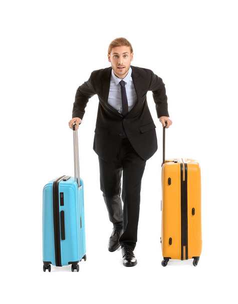 Young businessman with luggage isolated on white - Foto, Bild