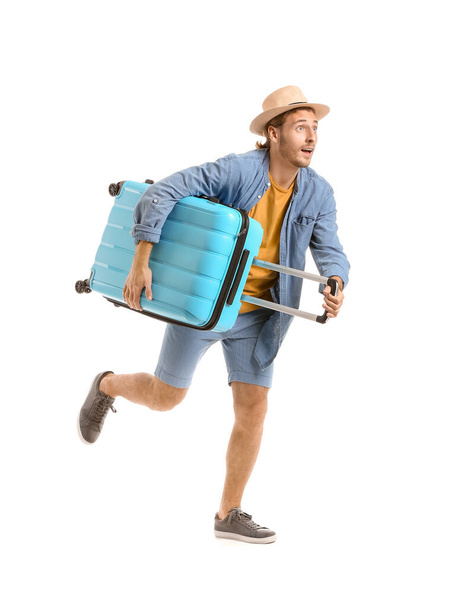 Hurrying tourist with luggage isolated on white - Foto, imagen