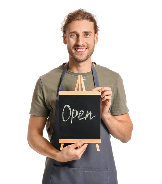 Male florist holding chalkboard with text OPEN on white background - Foto, imagen