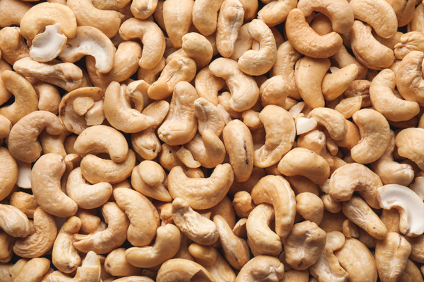 Many tasty cashew nuts as background - Foto, immagini