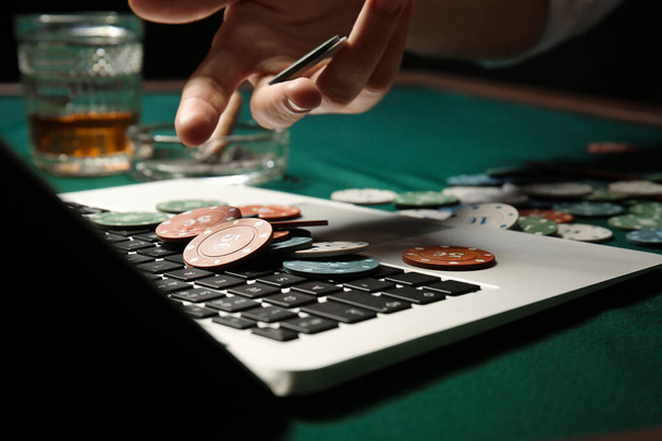 Young man playing poker online, closeup - Photo, Image