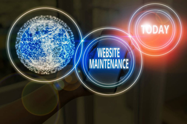 Text sign showing Website Maintenance. Conceptual photo act of regularly checking your website for issues Elements of this image furnished by NASA. - Photo, Image