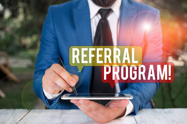 Text sign showing Referral Program. Conceptual photo internal recruitment method employed by organizations Businessman pointing with pen in empty copy space. - Photo, Image