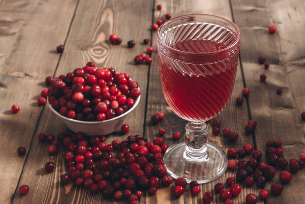 red vitamin drink. cranberry juice and fresh cranberries on the table - Photo, Image