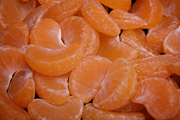 Many peeled mandarin slices. Mandarin background. - 写真・画像