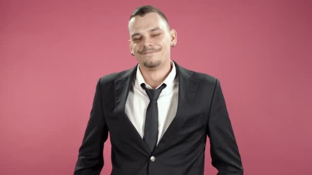 Young business man smiling over pink background - Felvétel, videó