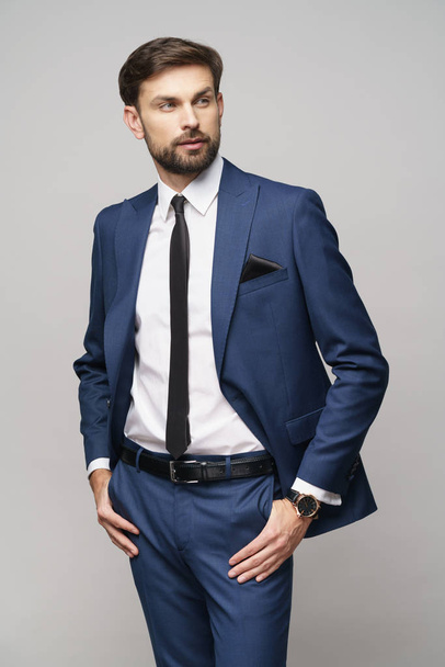 studio photo of young handsome businessman wearing suit - Foto, Imagen